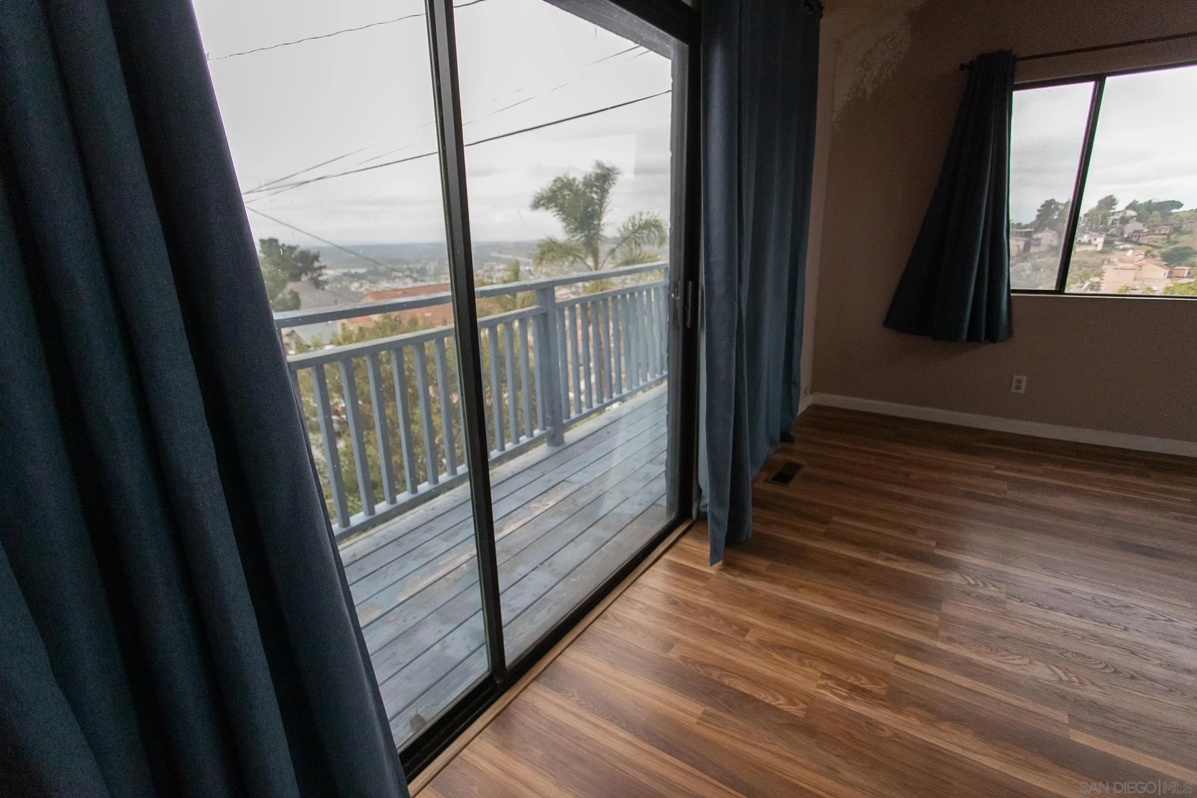 9802 Eucalyptus Street Spring Valley, CA 91977 - Photo 4 of 40 a view of a balcony with wooden floor