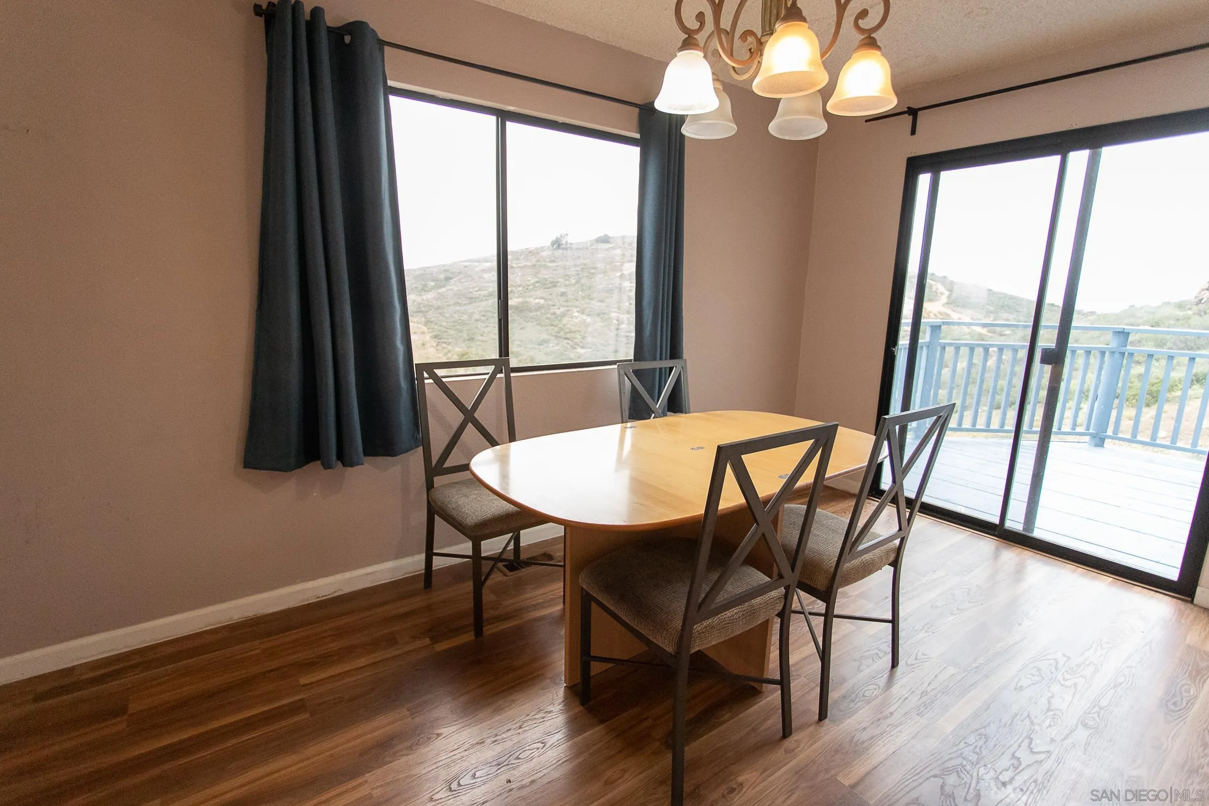 9802 Eucalyptus Street Spring Valley, CA 91977 - Photo 8 of 40 a view of a dining room with furniture window and wooden floor