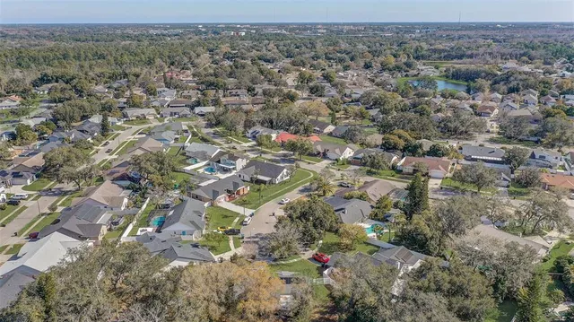an aerial view of a houses with a yard