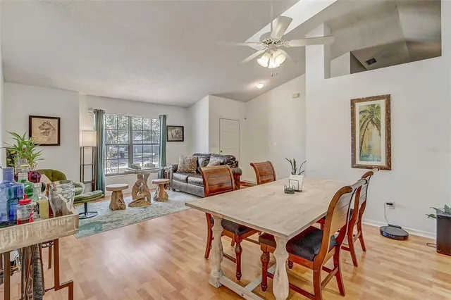 a living room with furniture a chandelier and a table
