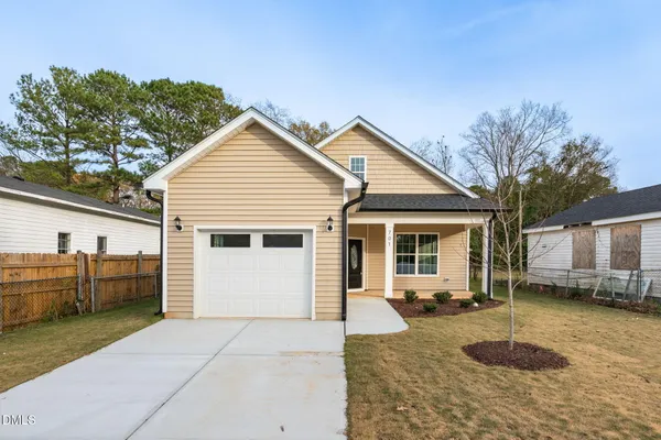 a view of a house with backyard and sitting area