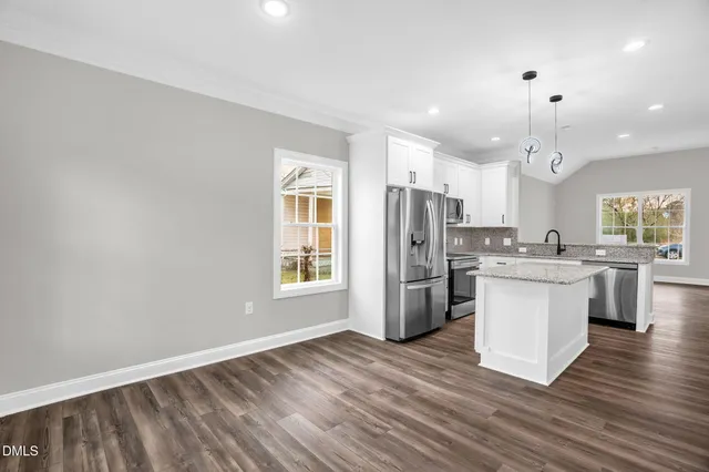 a view of a kitchen with wooden floor and a kitchen