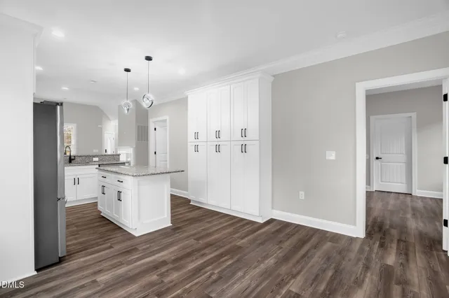 a kitchen with a refrigerator and a sink