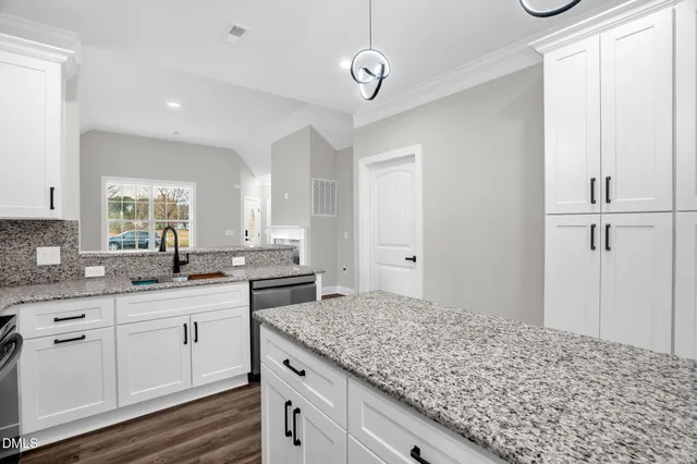 a kitchen with stainless steel appliances granite countertop a sink refrigerator and microwave