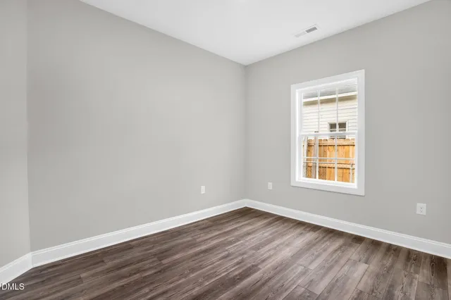 a bathroom with a granite countertop toilet sink and mirror