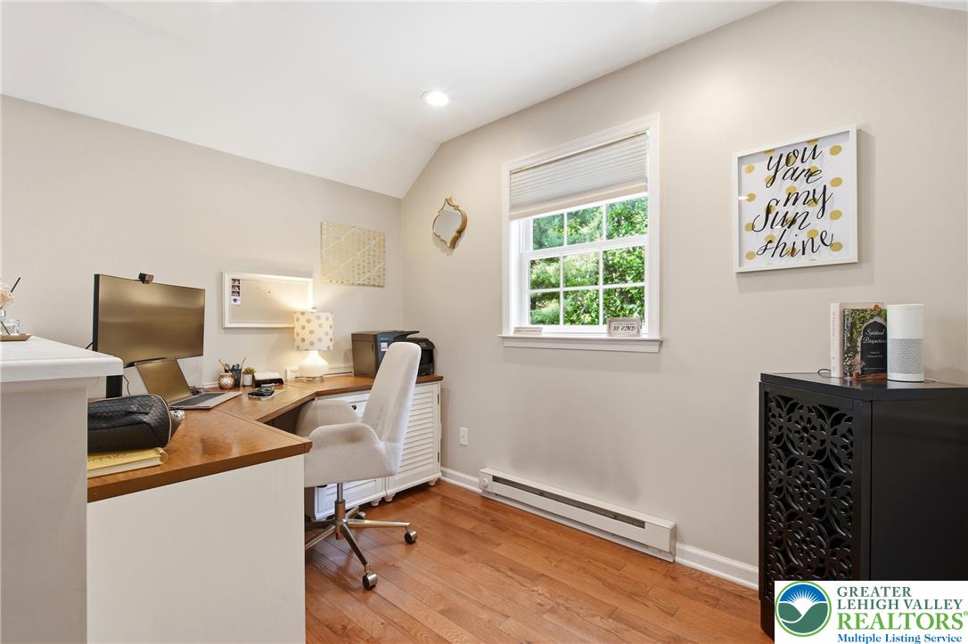 115 West Butternut Road Hellertown, PA 18055 - Photo 39 of 97 A dedicated home office provides ample space for productivity with warm hardwood flooring and a view of the natural surroundings.