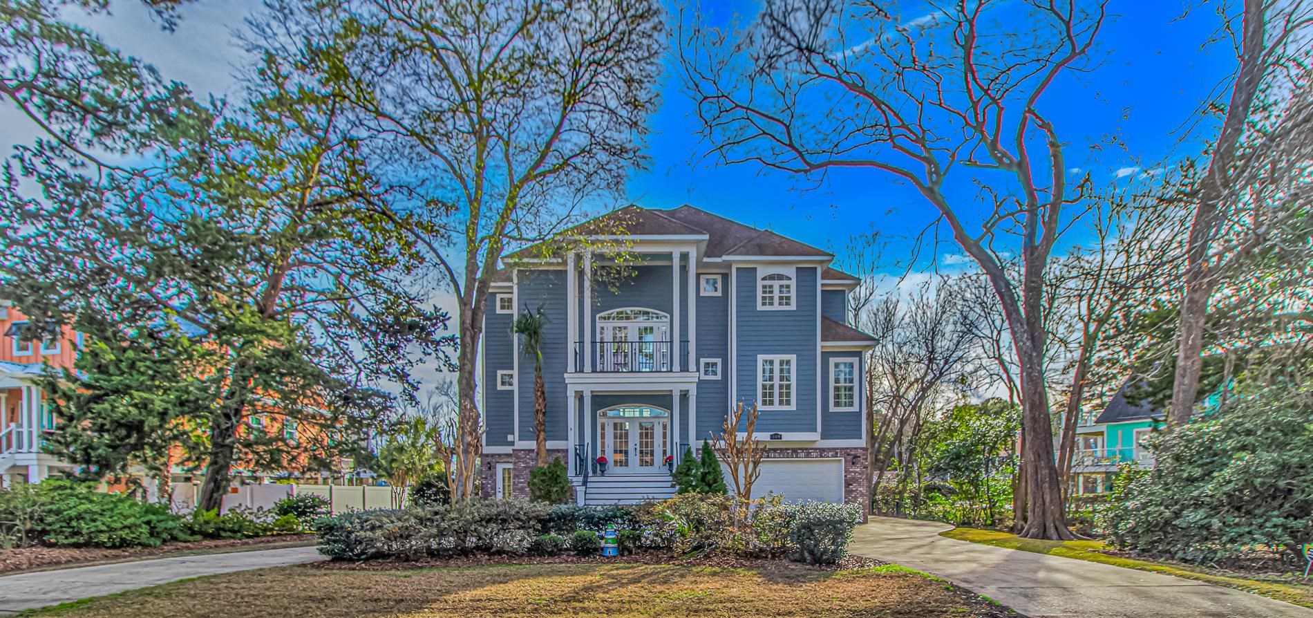 View of front of property with driveway, an attached garage, and french doors