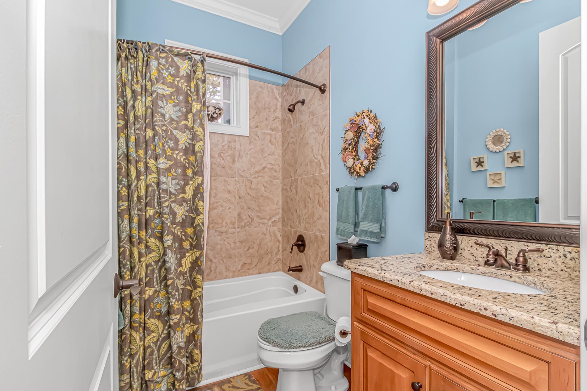 309 North Myrtle Drive Surfside Beach, SC 29575 - Photo 12 of 40 Bathroom featuring vanity, shower / bath combo with shower curtain, and crown molding