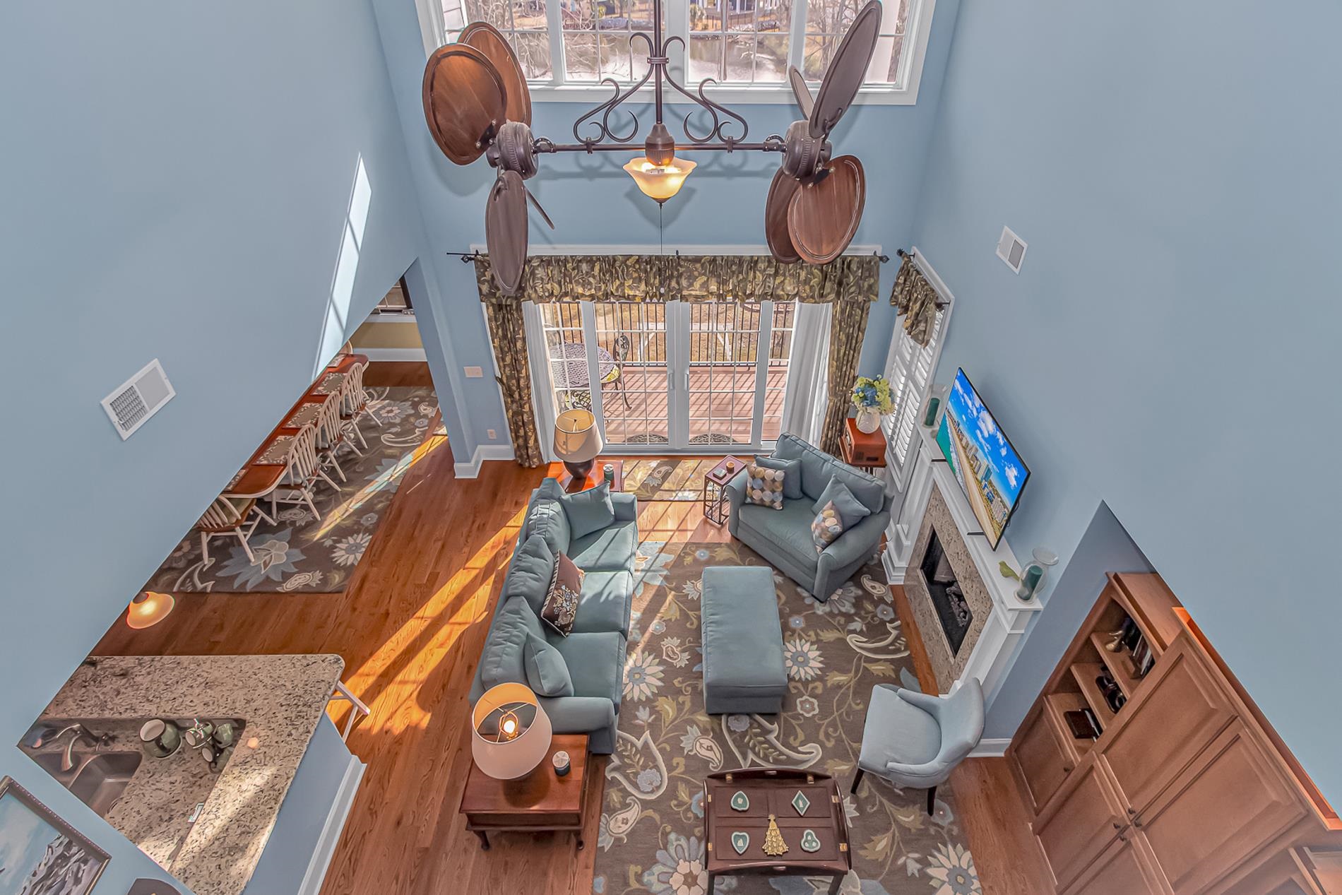 309 North Myrtle Drive Surfside Beach, SC 29575 - Photo 16 of 40 Living area with a fireplace with raised hearth, a towering ceiling, and wood finished floors