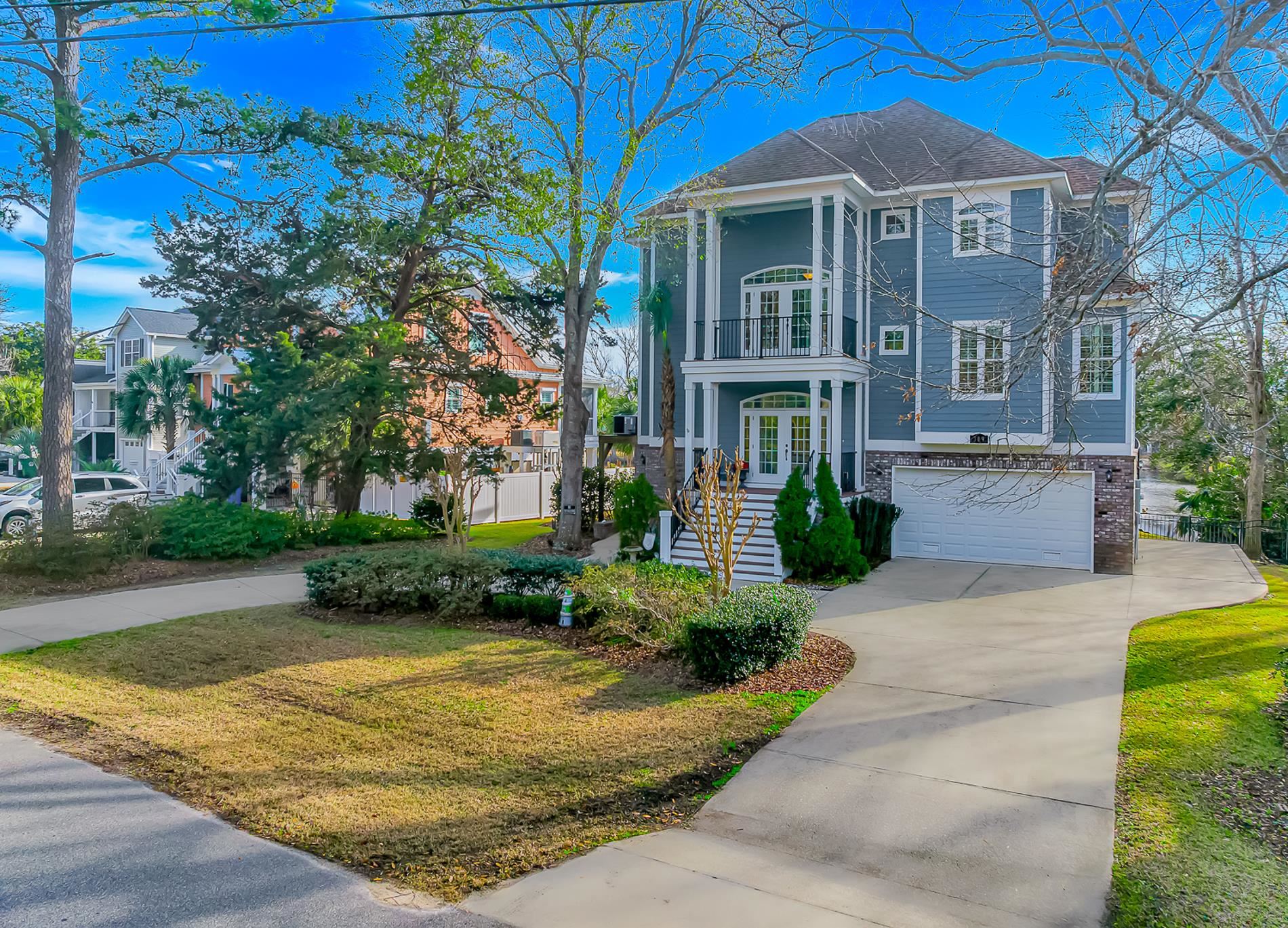 309 North Myrtle Drive Surfside Beach, SC 29575 - Photo 2 of 40 View of front of property featuring french doors, a front yard, concrete driveway, an attached garage, and a balcony