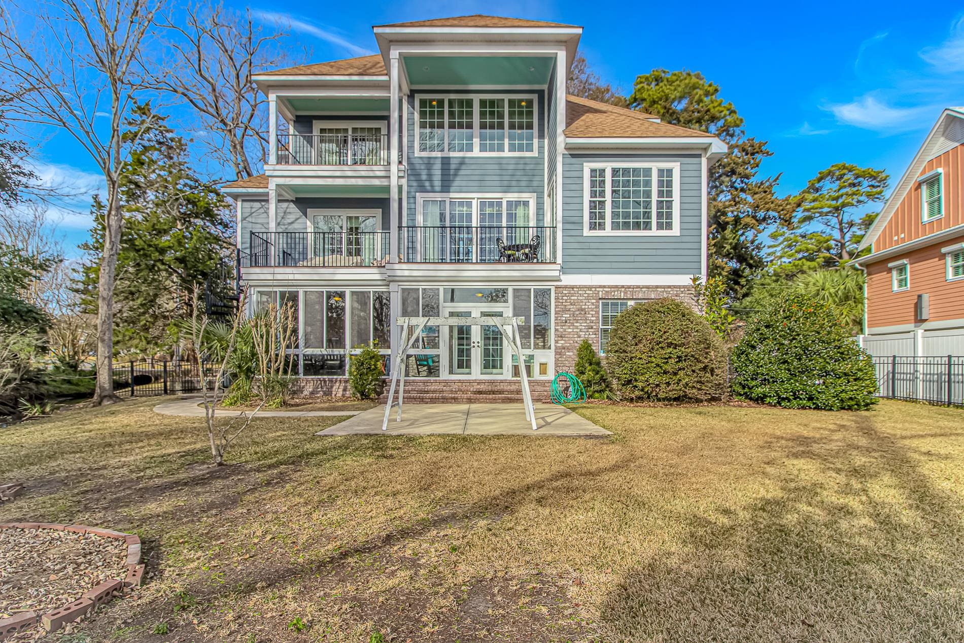 309 North Myrtle Drive Surfside Beach, SC 29575 - Photo 35 of 40 Back of property featuring a balcony, french doors, brick siding, a patio, and a sunroom