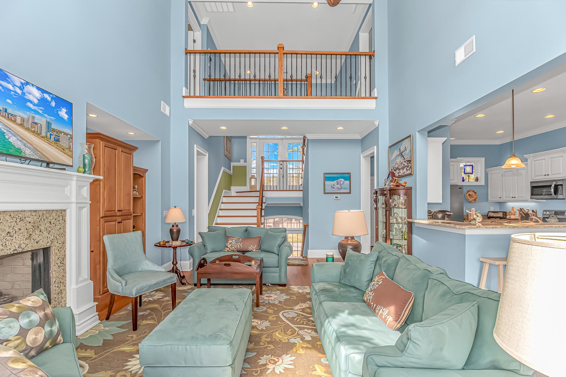 309 North Myrtle Drive Surfside Beach, SC 29575 - Photo 4 of 40 Living room featuring wood finished floors, a towering ceiling, a fireplace, recessed lighting, and crown molding