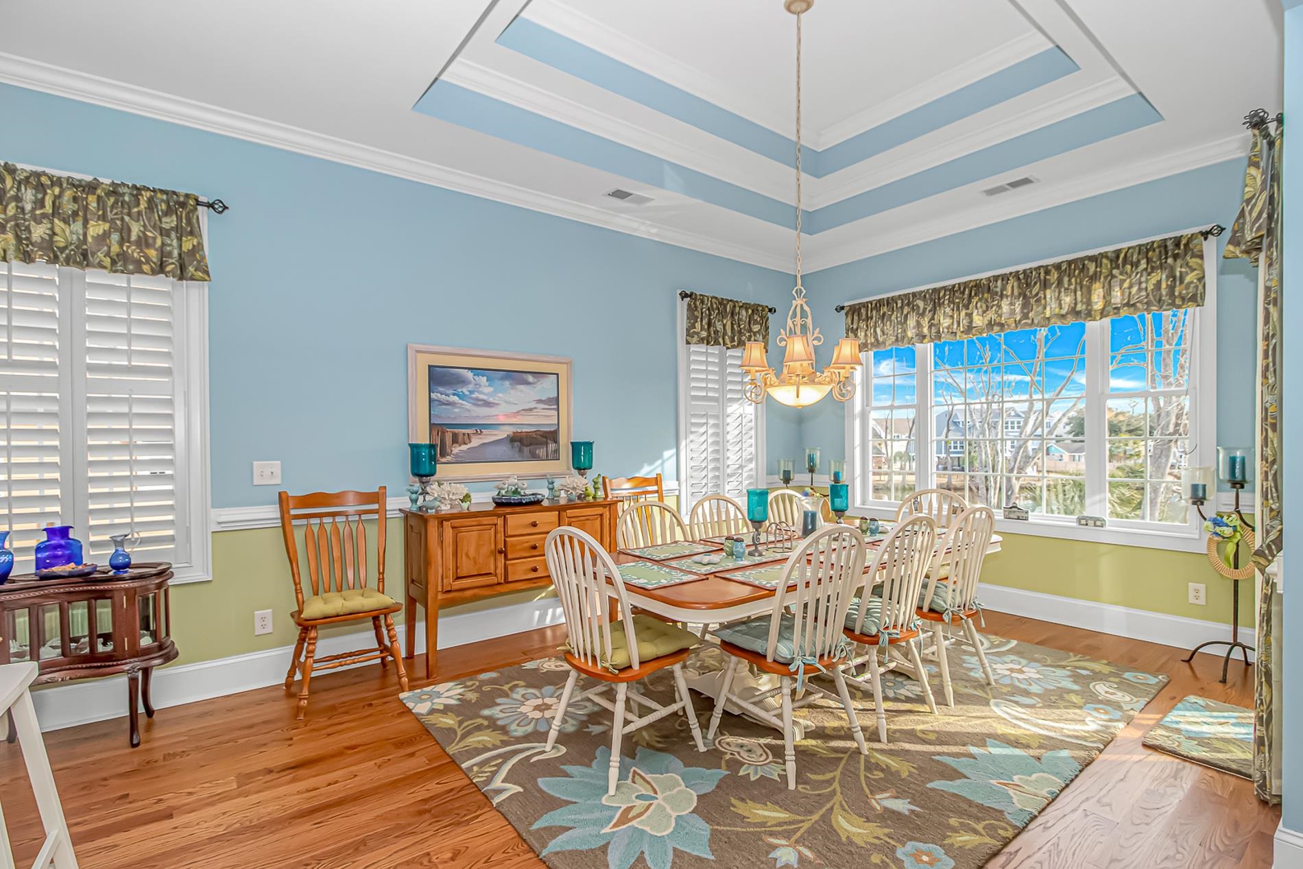 309 North Myrtle Drive Surfside Beach, SC 29575 - Photo 5 of 40 Dining area with light wood-style floors, a chandelier, crown molding, and a raised ceiling