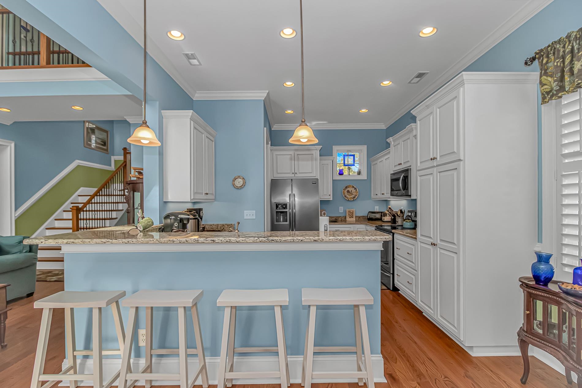 309 North Myrtle Drive Surfside Beach, SC 29575 - Photo 6 of 40 Kitchen with a breakfast bar area, light stone countertops, white cabinetry, recessed lighting, and stainless steel appliances