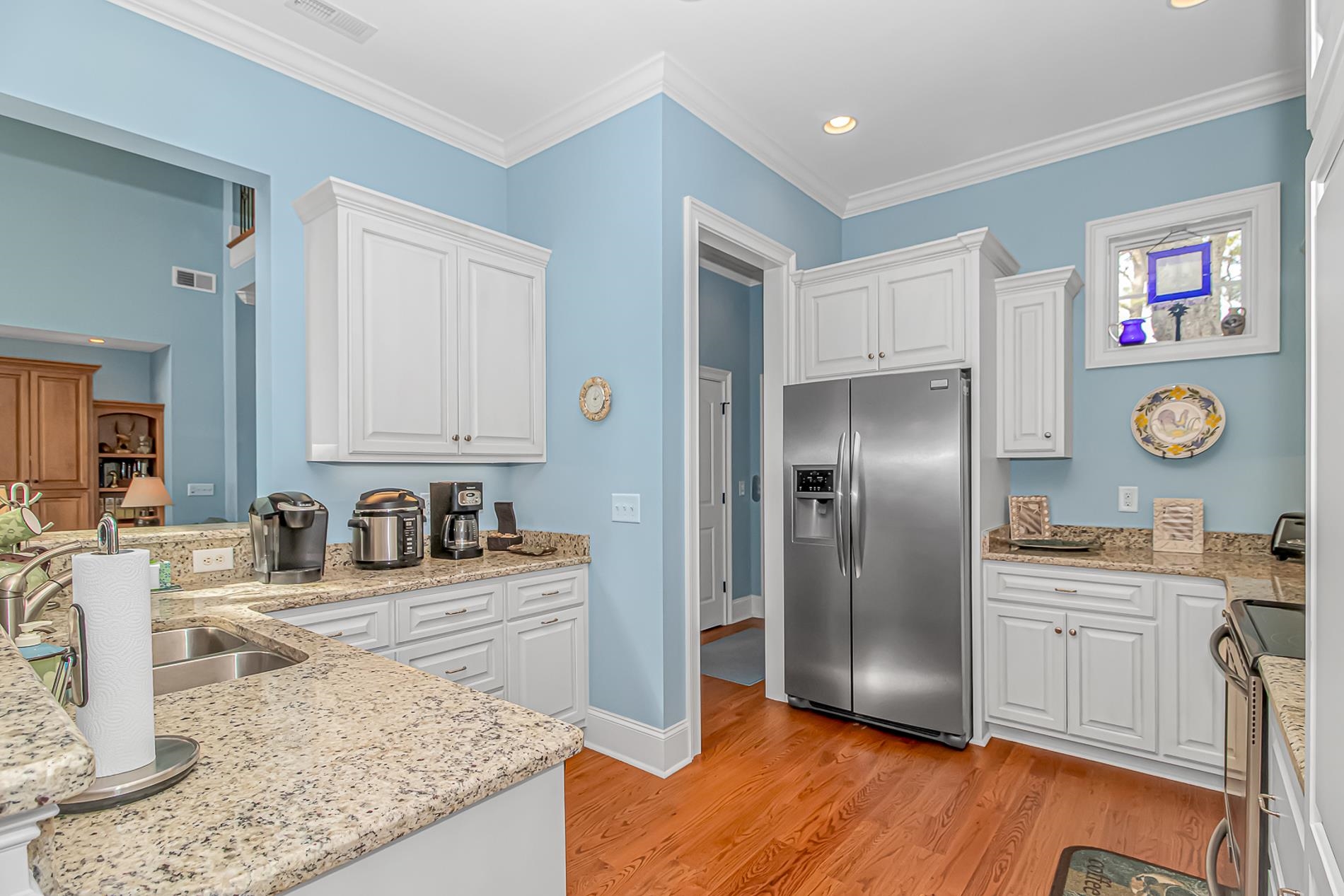 309 North Myrtle Drive Surfside Beach, SC 29575 - Photo 7 of 40 Kitchen featuring stainless steel appliances, white cabinetry, light stone counters, crown molding, and recessed lighting