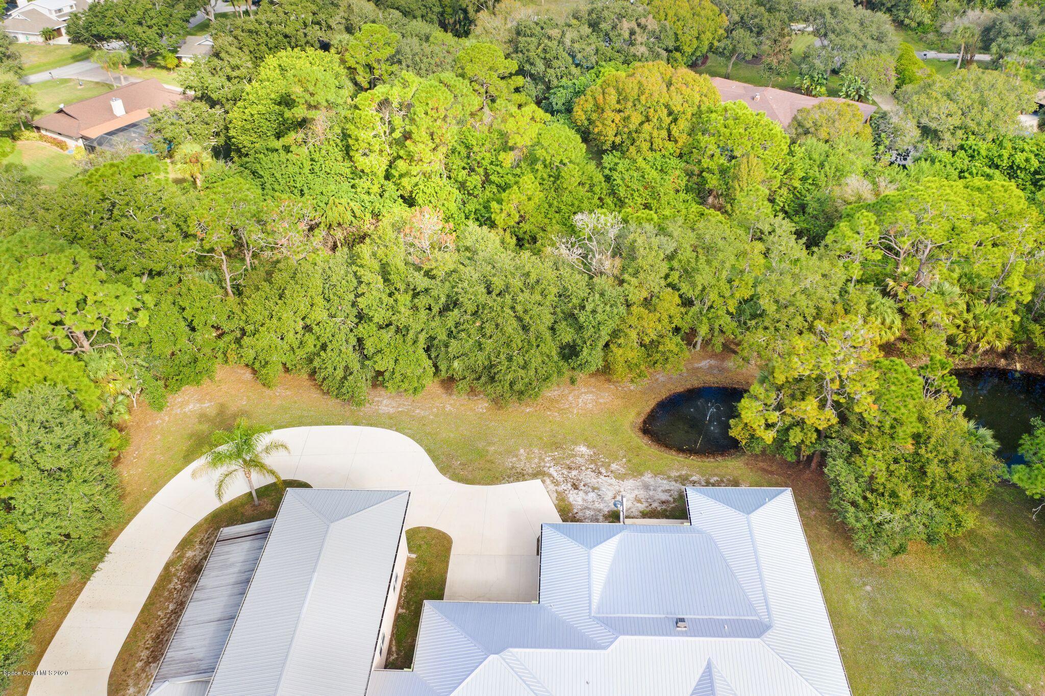 3602 Palomino Road Melbourne, FL 32934 - Photo 41 of 43 150' x 42' Pond Visible from 3 Rooms