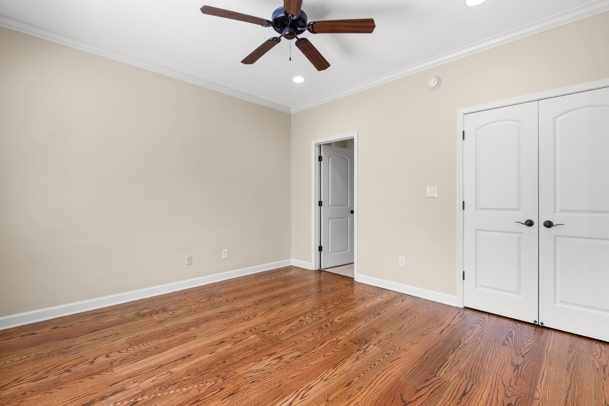 2275 McVay Road, Unit 2275 Germantown, TN 38138 - Photo 15 of 40 an empty room with wooden floor ceiling fan and windows
