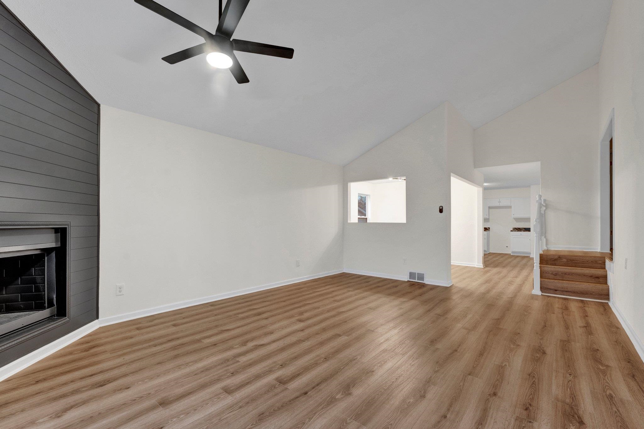 4195 Bishops Bridge Road Memphis, TN 38118 - Photo 4 of 19 a view of empty room with wooden floor and fireplace