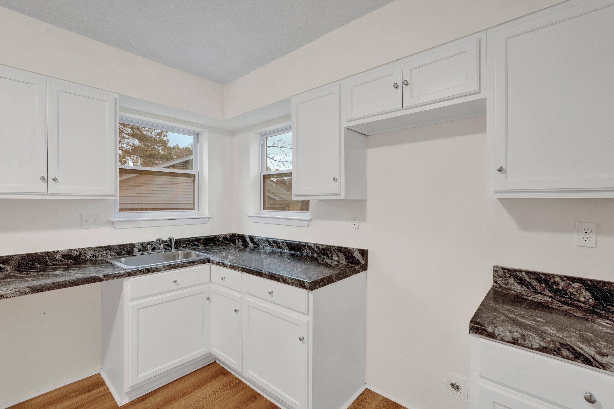 4195 Bishops Bridge Road Memphis, TN 38118 - Photo 9 of 19 a white kitchen with sink and cabinets