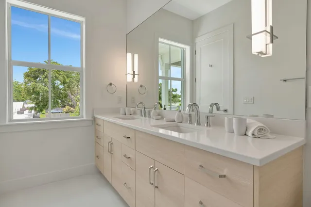 a bathroom with a double vanity sink and a mirror
