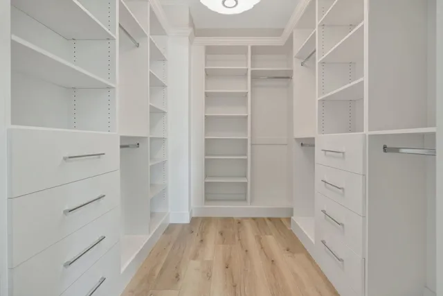 a view of walk in closet with empty racks