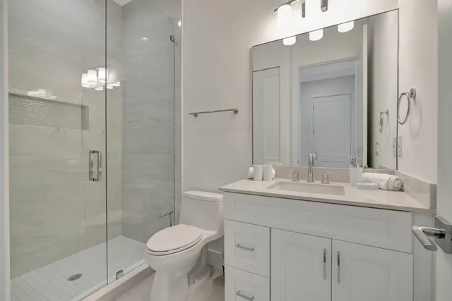 a bathroom with a sink toilet and shower