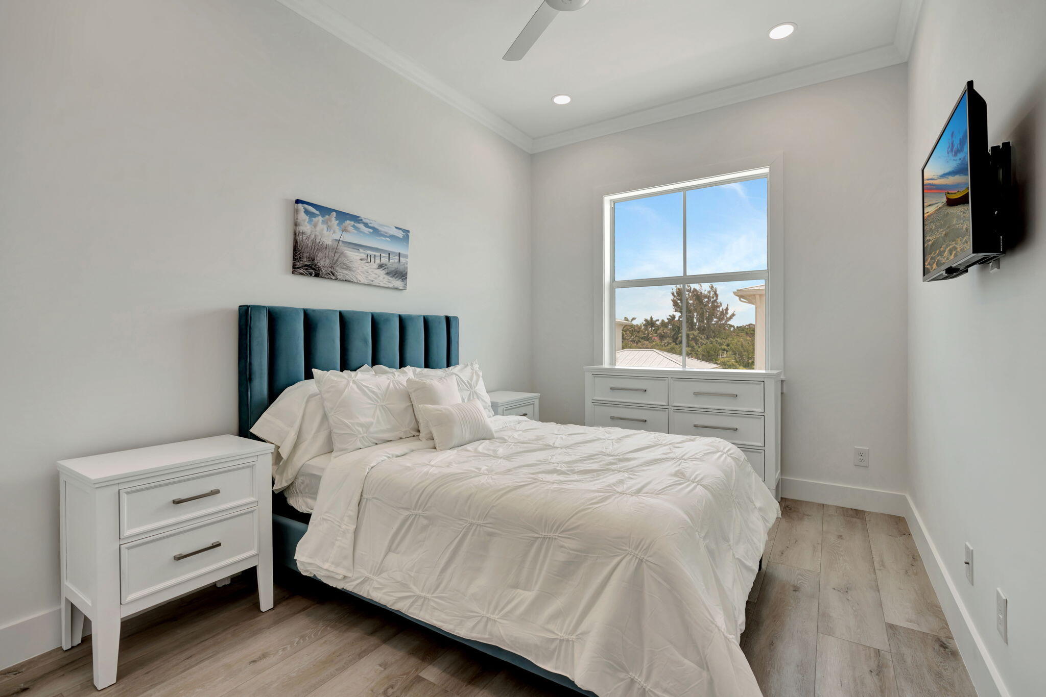 4662 Southeast Manatee Terrace Stuart, FL 34997 - Photo 22 of 32 a bedroom with a bed and a flat screen tv