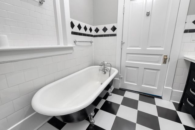 a bathroom with a bathtub and a sink