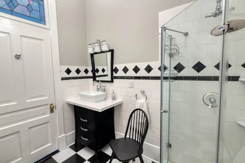 a bathroom with a sink a toilet and shower