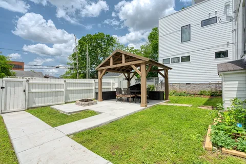 a view of a house with backyard and porch