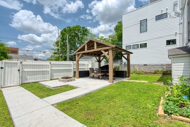 a view of a house with backyard and porch