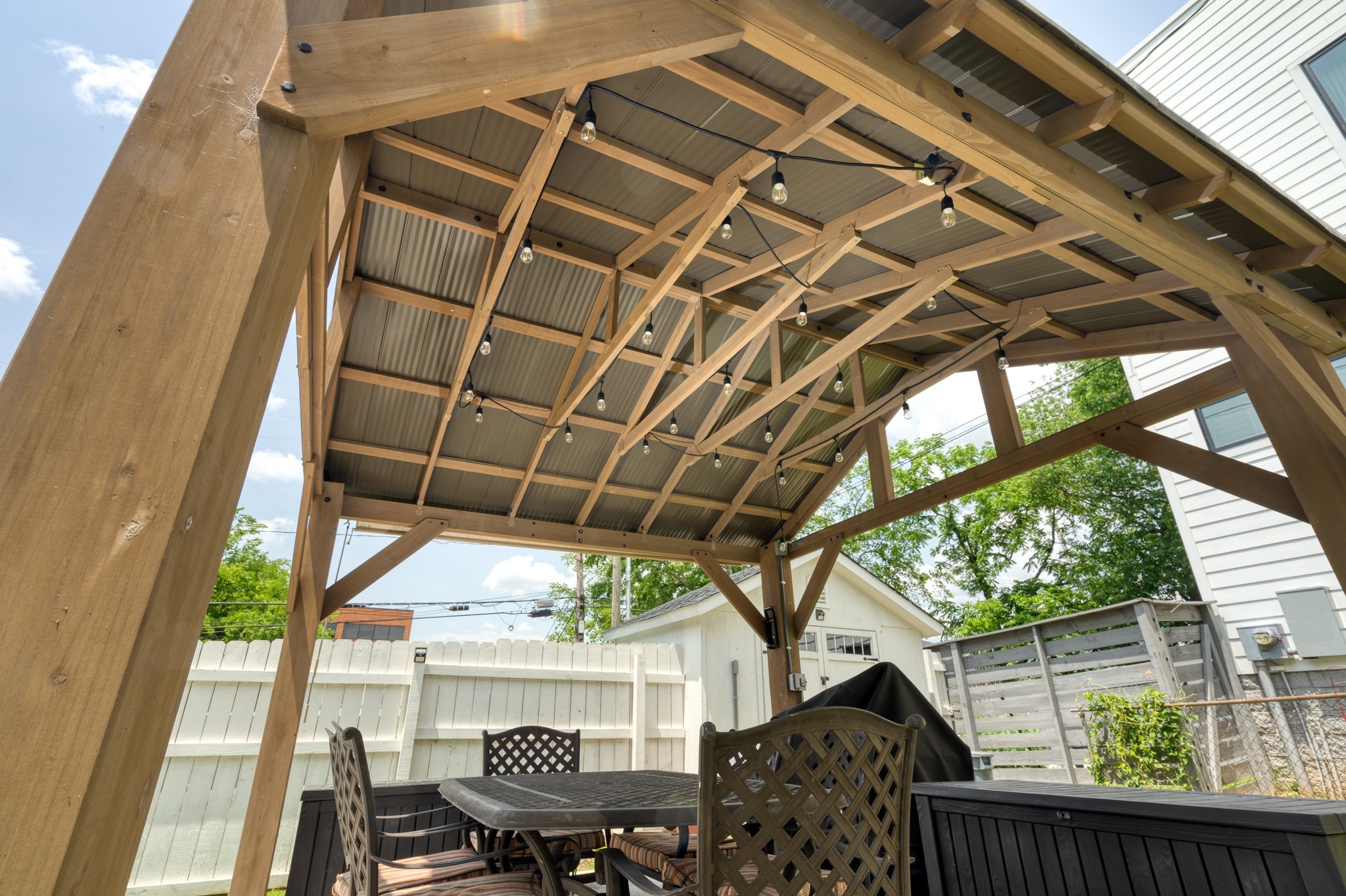 1025 Villa Place Nashville, TN 37212 - Photo 30 of 37 a view of patio with table and chairs under an umbrella with a small garden