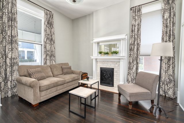 a living room with furniture and a fireplace