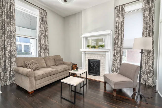 a living room with furniture and a fireplace