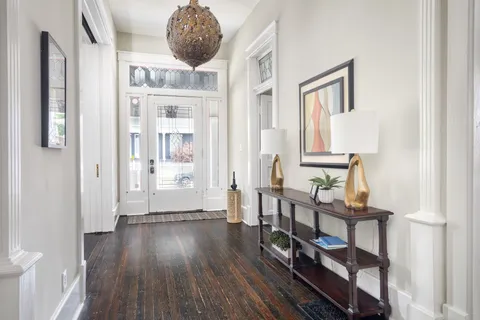 a very nice looking room with wooden floor and a bathroom