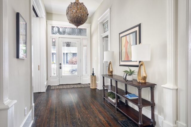 a very nice looking room with wooden floor and a bathroom