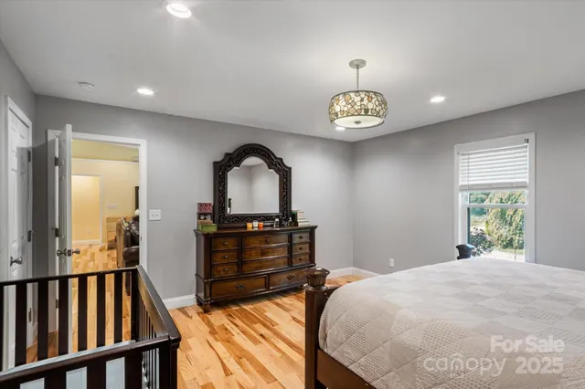 a bedroom with a bed and a chandelier