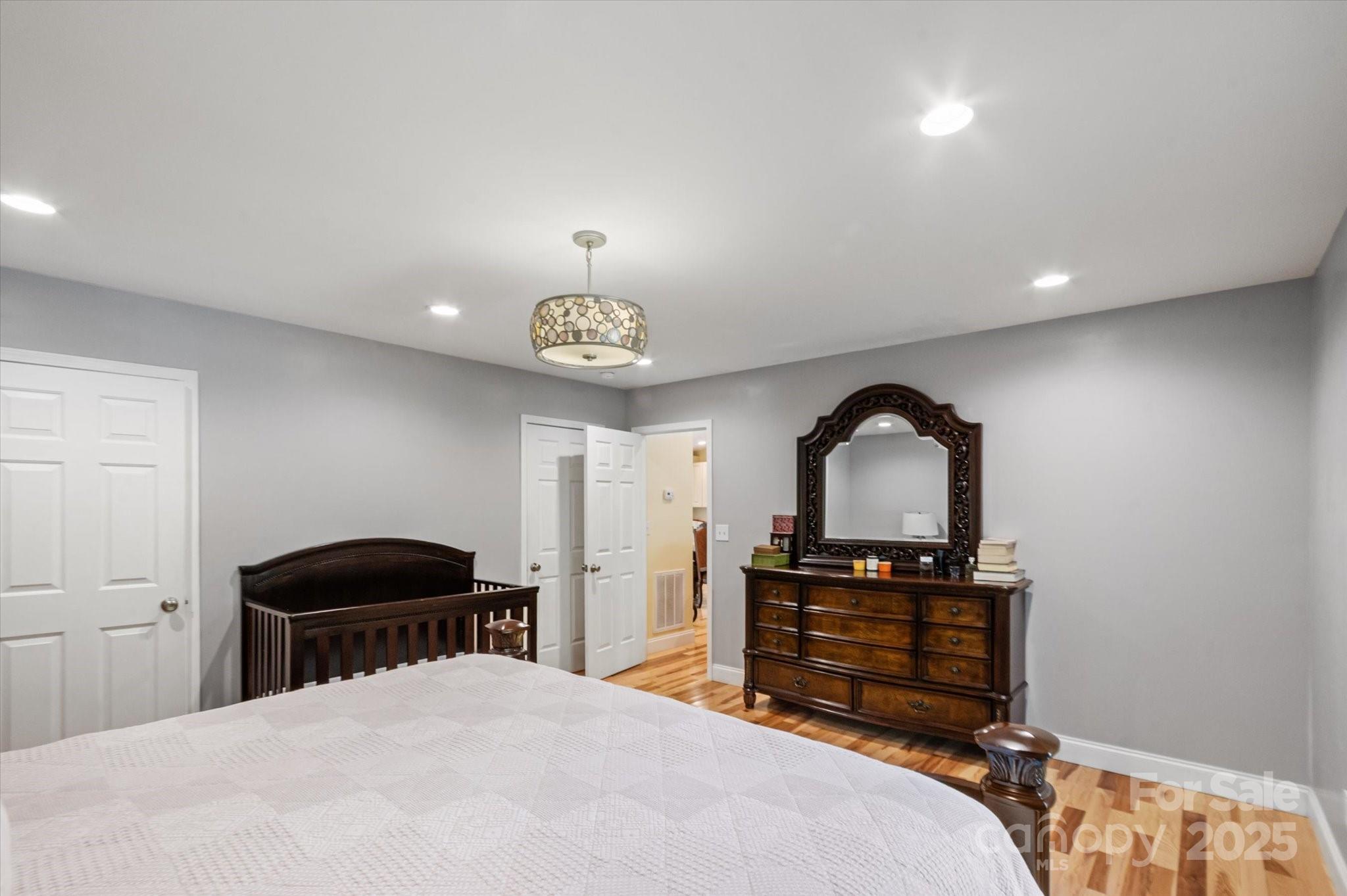 40 Alabama Avenue Marion, NC 28752 - Photo 12 of 38 a bedroom with a bed and a chandelier