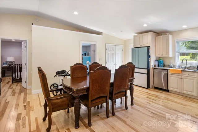 a view of a dining room with furniture and a kitchen