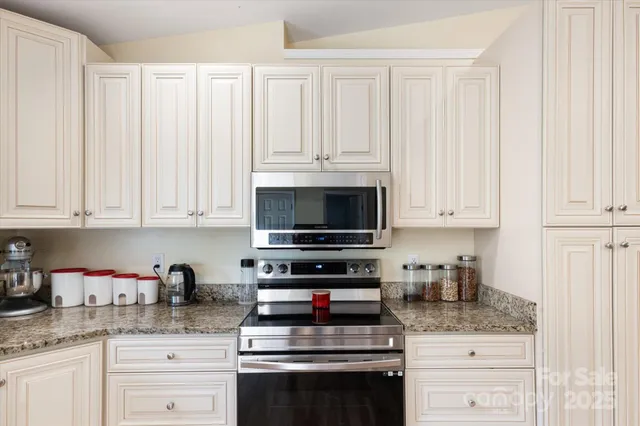 a kitchen with a sink cabinets and window