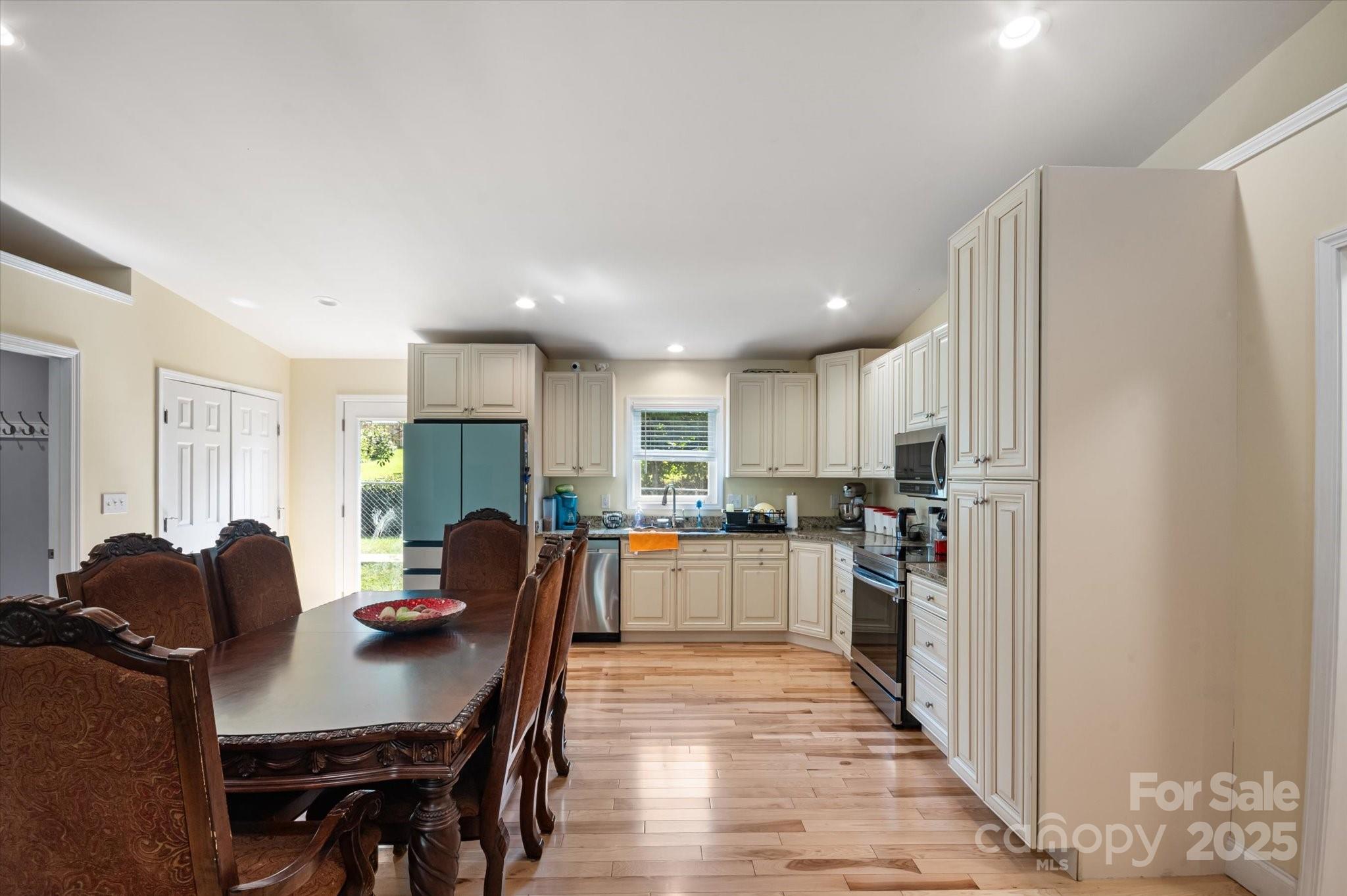 40 Alabama Avenue Marion, NC 28752 - Photo 20 of 38 a kitchen with stainless steel appliances granite countertop a refrigerator a stove a sink dishwasher with a dining table and chairs