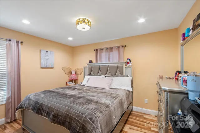 a playing room with furniture and a wooden floor