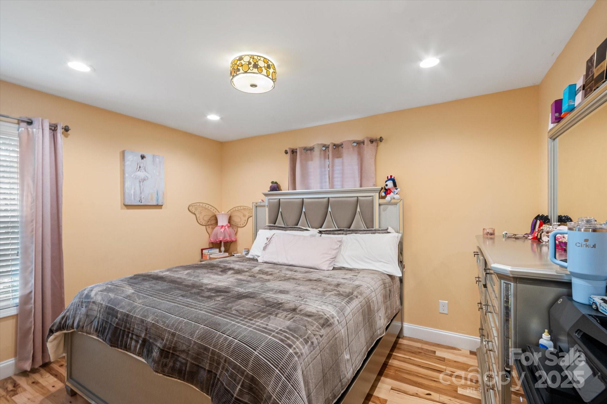 40 Alabama Avenue Marion, NC 28752 - Photo 35 of 38 a bedroom with a bed and a chandelier