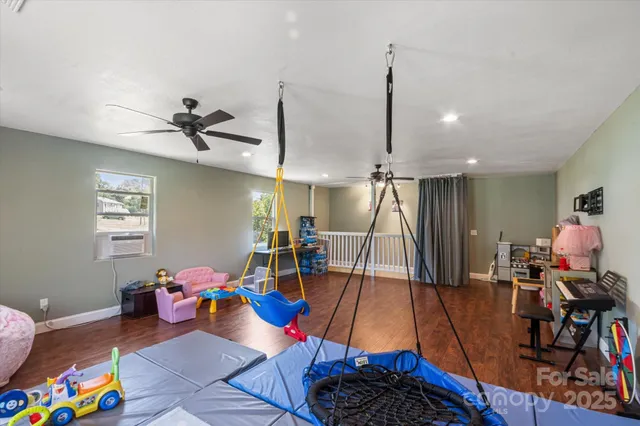 a living room with lots of furniture and a wooden floor