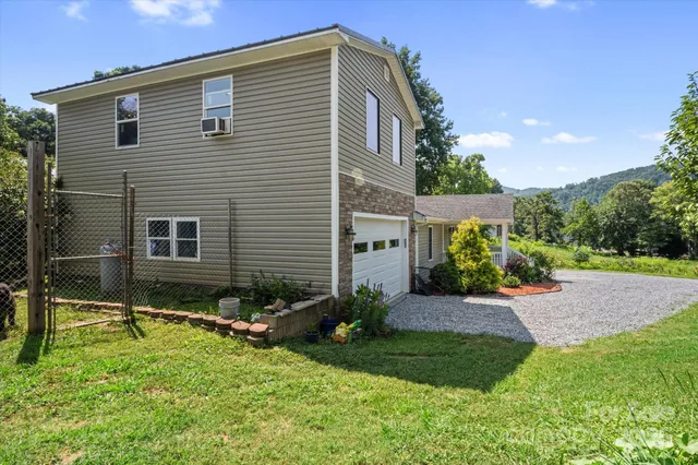 a backyard of a house with plants and tree