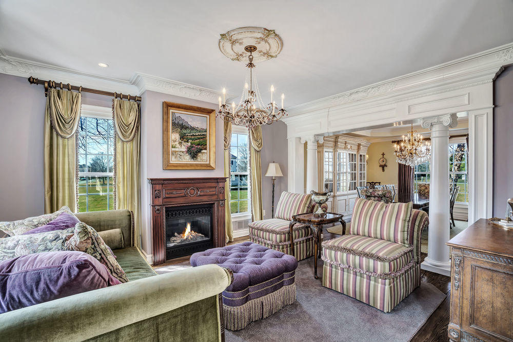 231 Pin Oak Road Freehold, NJ 07728 - Photo 14 of 74 a living room with furniture a chandelier and a fireplace