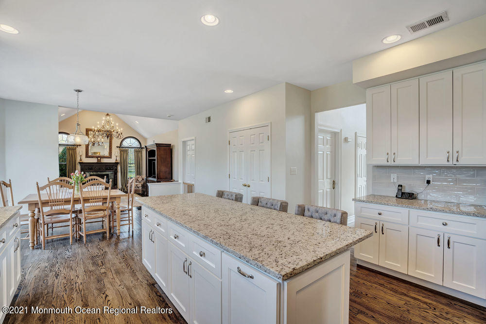231 Pin Oak Road Freehold, NJ 07728 - Photo 22 of 74 a kitchen with center island table and chairs