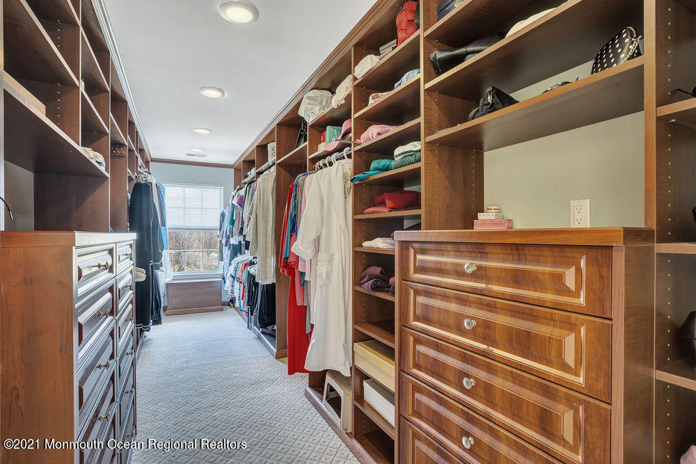 231 Pin Oak Road Freehold, NJ 07728 - Photo 40 of 74 a view of walk in closet with clothes and shoes