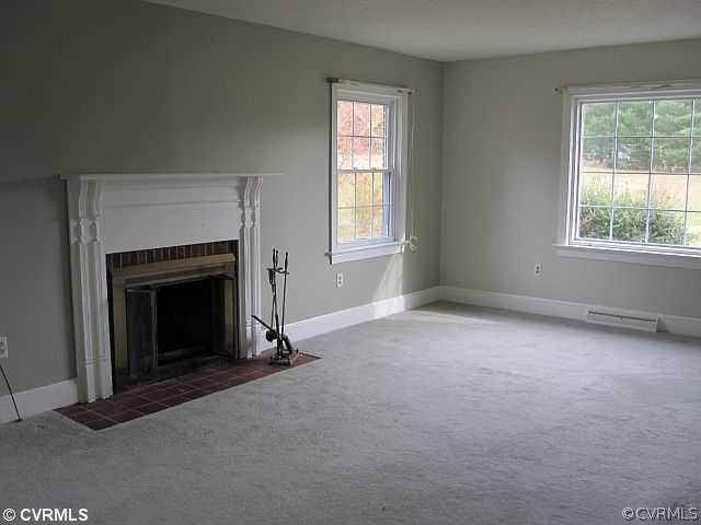 259 Crescent Road Farmville, VA 23901 - Photo 4 of 12 an empty room with a fireplace and windows