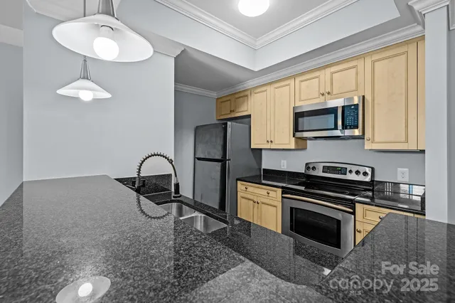 a kitchen with stainless steel appliances granite countertop a stove a sink dishwasher a microwave oven with granite countertops and cabinets